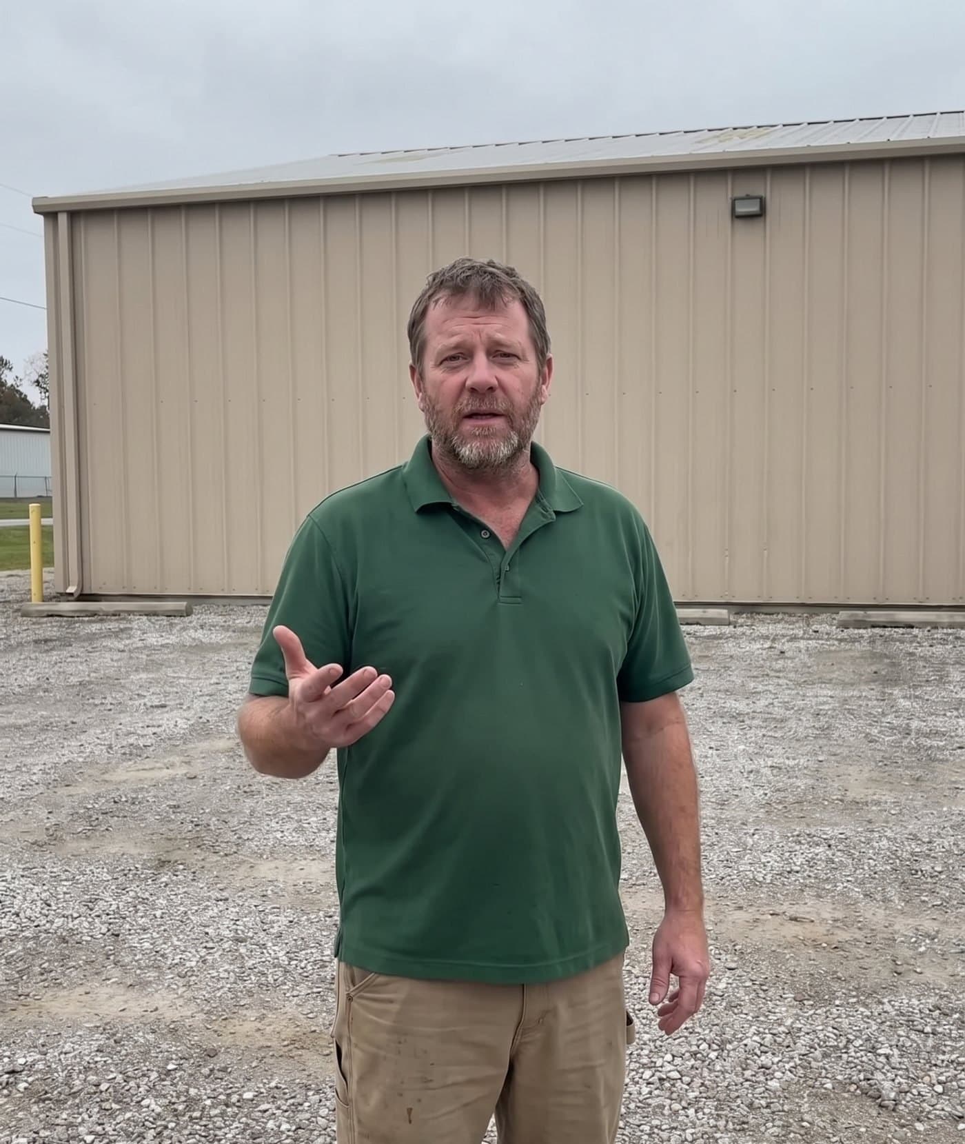 The raw shot: the business owner filmed in a plain gravel lot in flat light